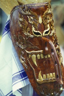 THAILAND, Loei Province, Dan Sai, Phi Ta Khon or Spirit Festival. Person wearing elaborate spirit