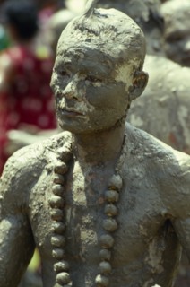 THAILAND, Loei Province, Dan Sai, Phi Ta Khon or Spirit Festival. Mud man covered in a thick layer