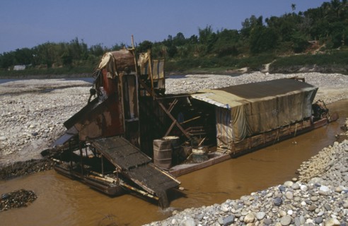 MYANMAR, Kachin State, Manhkring, Gold dredger on the upper Ayeyarwady River operated by