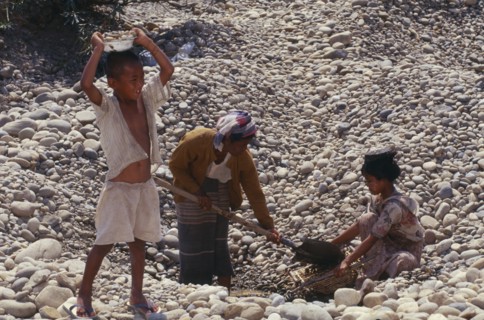MYANMAR, Kachin State, Myitkyina, People gathering stones for road building on the upper Ayeyarwady