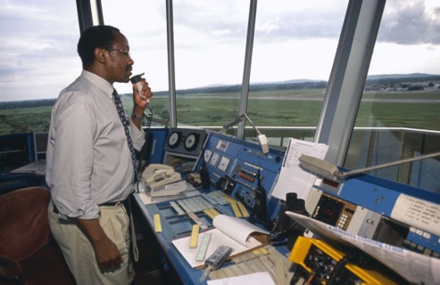 TANZANIA, Dar es Salaam, Man using radio in airport control tower in Dar es Salaam airport.