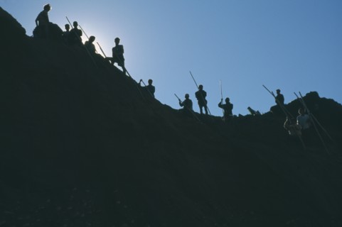 MYANMAR, Work, Mining, Gold workers silhouetted against sky at the source of the Ayeyarawady River