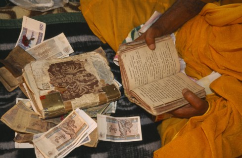 MYANMAR, General, Cropped view of Hindu priest receiving alms during festival at the confluence of