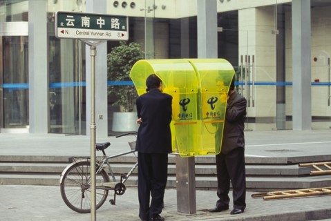CHINA, Shanghai, People using city centre public telephone.