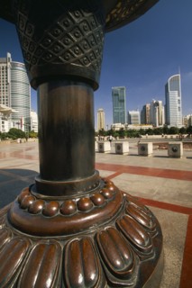 CHINA, Shanghai, People’s Square.  Circular paved area surrounded by skyscrapers with part view of