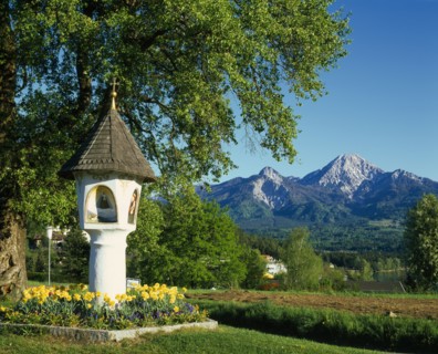 AUSTRIA, Karnten, Egg, Shrine with wooden tiled roof and alcoves painted with religious subjects in