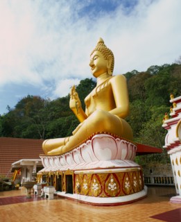THAILAND, Phuket Province, Phuket, Big Buddha Temple.  Large seated golden Buddha figure in temple