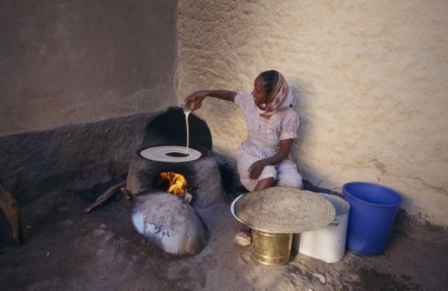 ERITREA, Keren, "Woman cooking injera, a type of sour, flat bread that accompanies most meals."