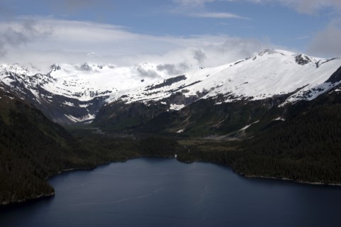 USA, Alaska, Prince William Sound, Aerial view over waters toward snow capped mountain peaks