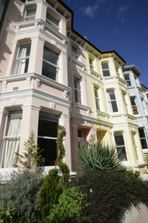 ENGLAND, East Sussex, Brighton, Brightly coloured terraced Kemp Town houses in Chesham Street