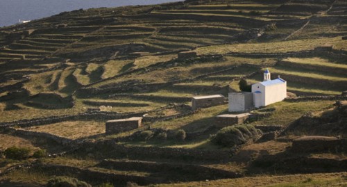 GREECE, Cyclades, Tinos, Religious shrine on a terraced hill side.