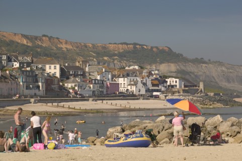 ENGLAND, Dorset, Lyme Regis, View of the town from the beach.
