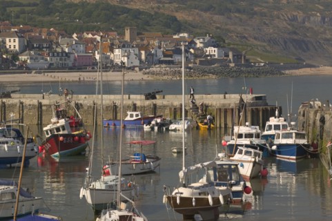 ENGLAND, Dorset, Lyme Regis, View of the town across the harbour from The Cobb.