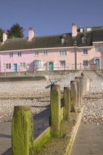 ENGLAND, Dorset, Lyme Regis, View of old fishermens cottages along the waterfront from the beach