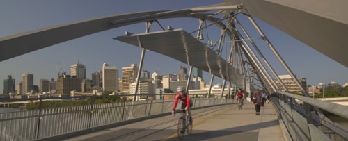 AUSTRALIA, Queensland, Brisbane, Cyclists and pedestrians crossing the Goodwill Bridge.