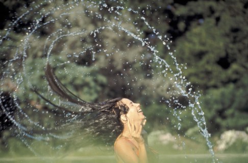 PEOPLE, Women, Woman in a swimming pool flings her wet hair over her head