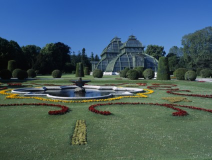 AUSTRIA, Vienna, Schonbrunn Palace formal gardens with fountain and the Palm House