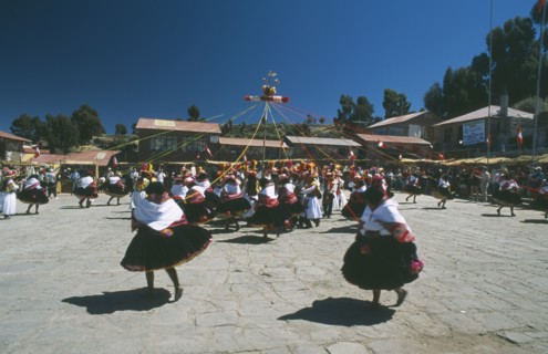 PERU, Puno, Lake Titicaca, Taquile Island. Dancers in local costume take part in Island Festival