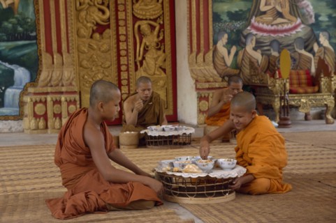 LAOS, Vientiane, Buddhist monks eating meal in Wat Chan.