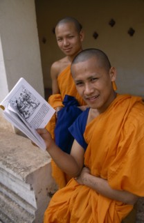 LAOS, Vientiane, Young Buddhist monks with book.