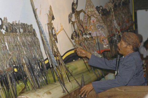 INDONESIA, Java, Shadow puppeteer near Borobudur.