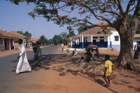GUINEA BISSAU, San Domingos, Street scene with people and roadside vendor in town in the Casheu
