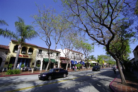 USA, California, Santa Barbara, View along State Street with shops and cafes and passing cars