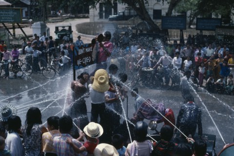 MYANMAR, Mandalay, Buddhist Water Festival.  Crowds spraying water from open topped jeep.