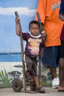 WEST INDIES, St Vincent & The Grenadines, Union Island, Young boy with a balloon in his t-shirt at