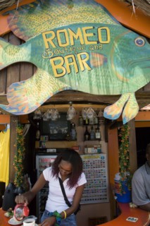 WEST INDIES, St Vincent & The Grenadines, Union Island, Woman serving coffee at roadside bar in