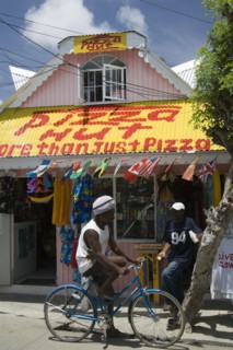WEST INDIES, St Vincent & The Grenadines, Union Island, Men talking outside pizza restaurant and
