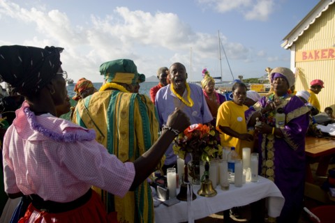 WEST INDIES, St Vincent & The Grenadines, Union Island, Women handing out donated goods amongst the