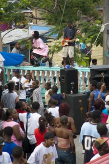 WEST INDIES, St Vincent & The Grenadines, Union Island, Singer and guitarist by sound system at