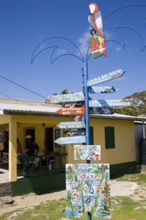 WEST INDIES, St Vincent & The Grenadines, Union Island, Signpost beside a rum shop in Clifton