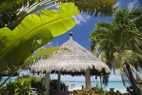 WEST INDIES, St Vincent & The Grenadines, Canouan, Palapa thatched entrance from hotel jetty at