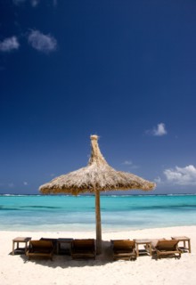 WEST INDIES, St Vincent & The Grenadines, Canouan, Palapa thatched shelter and sunbeds on Godahl