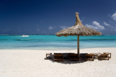 WEST INDIES, St Vincent & The Grenadines, Canouan, Palapa thatched shelter and sunbeds on Godahl