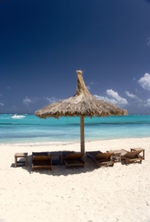 WEST INDIES, St Vincent & The Grenadines, Canouan, Palapa thatched shelter and sunbeds on Godahl
