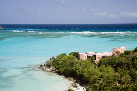 WEST INDIES, St Vincent & The Grenadines, Canouan, Pink villa on the headland of Carenage bay at