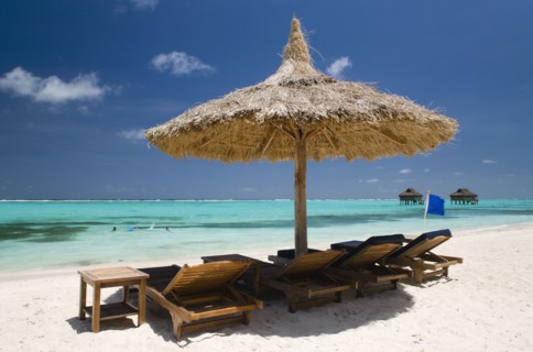 WEST INDIES, St Vincent & The Grenadines, Canouan, Palapa thatched shelter and sunbeds on Godahl