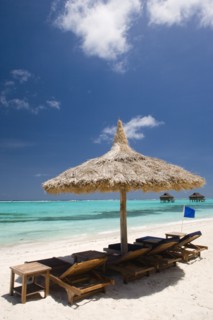 WEST INDIES, St Vincent & The Grenadines, Canouan, Palapa thatched shelter and sunbeds on Godahl