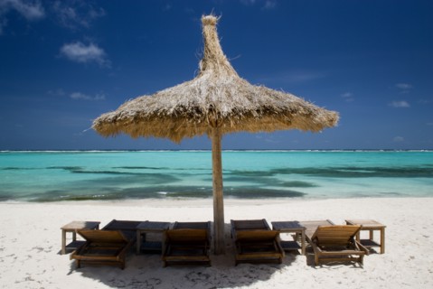 WEST INDIES, St Vincent & The Grenadines, Canouan, Palapa thatched shelter and sunbeds on Godahl