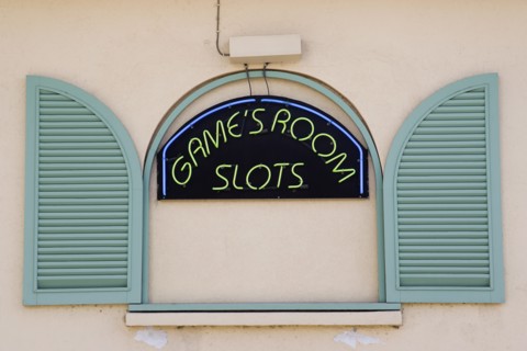 WEST INDIES, Barbados, St James, Gambling rooms neon sign in faked window promoting Slots in
