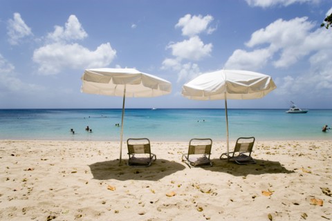 WEST INDIES, Barbados, St Peter, Sun shade umbrellas and chairs on Gibbes Beach with people