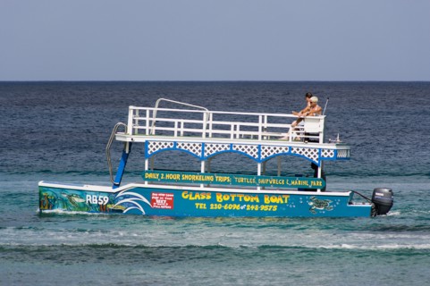 WEST INDIES, Barbados, St James, Tourists on glass bottom boat off the beach at Holetown