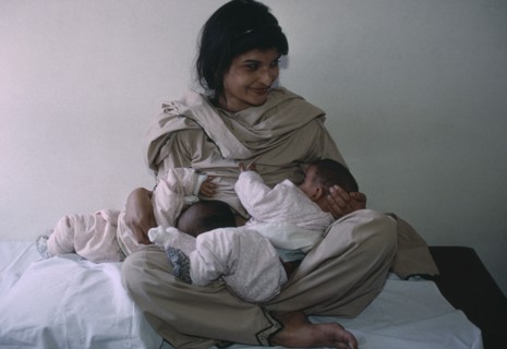 PAKISTAN, People, Pakistani woman breastfeeding her twins aged three months.
