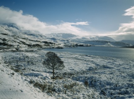 SCOTLAND, Highland, Loch Assynt, View south east across Loch in March snowfall.