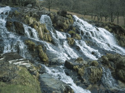 WALES, Snowdonia, Cwm y Llan Waterfall, Waterfall cascading over rocks in stream flowing south east