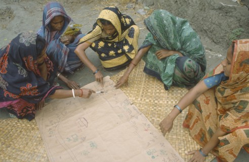 BANGLADESH, Khulna, Char Kukuri Mukuri, Women drawing a map of village as part of community