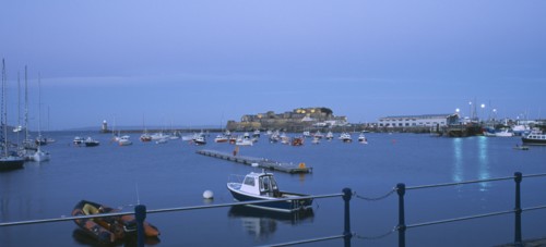 UNITED KINGDOM, Channel Islands, Guernsey, St Peter Port. Cornet Castle at dusk seen from across